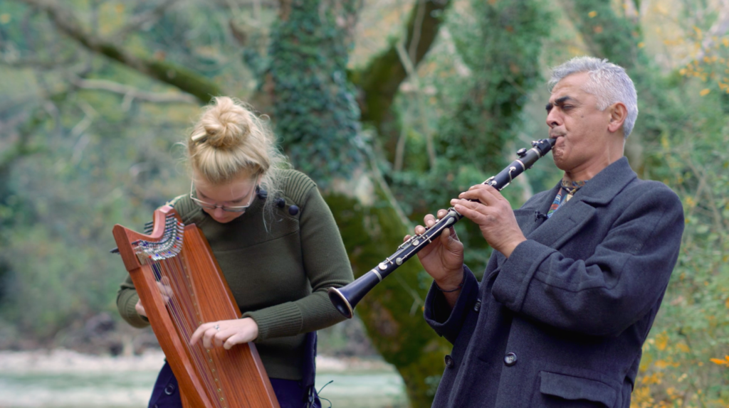 Two musicians playing their instruments outside