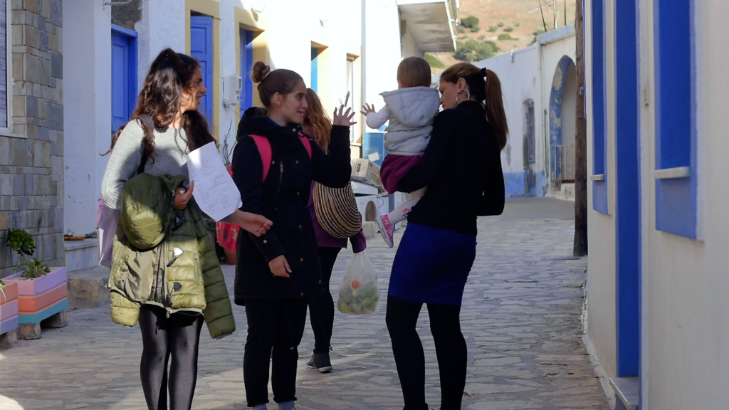 A group of young people talking in the streets of Greece