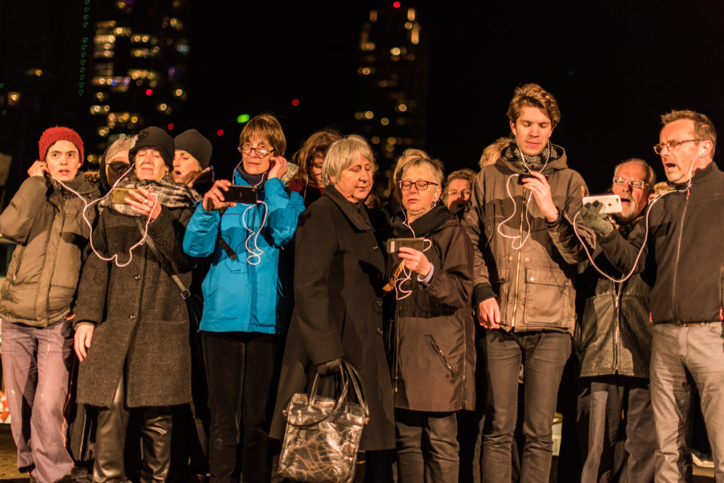 Group of people listening to their smartphones