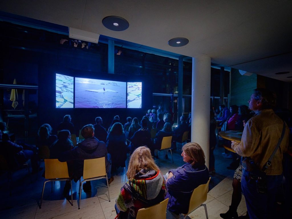 An audience watching the documentary film